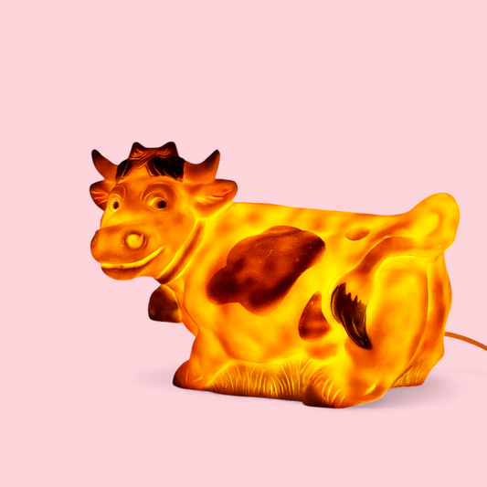 Lampka Heico krowa West Germany podświetlona, żółto-pomarańczowy blask, widok z boku