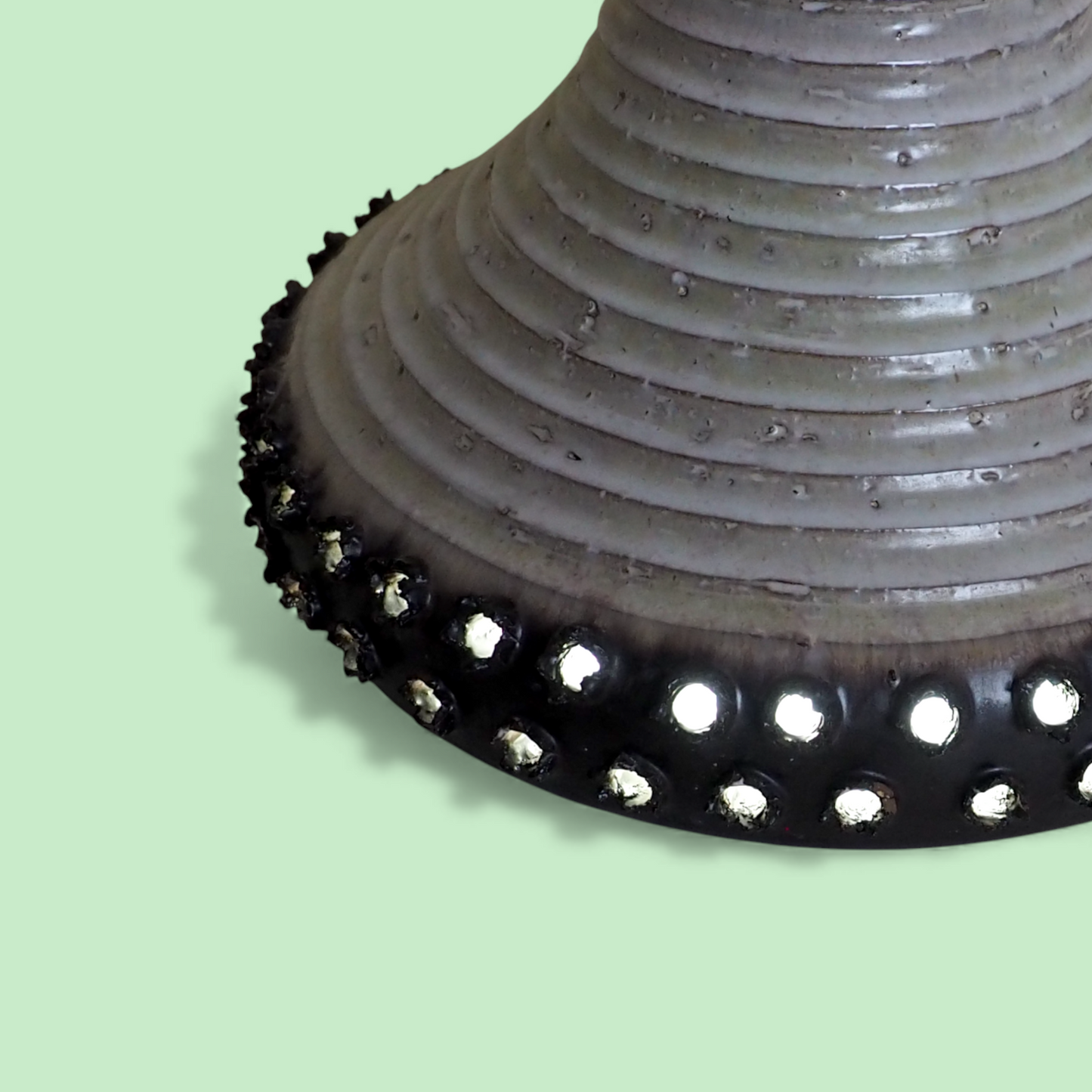 Detal dolnej krawędzi duńskiego klosza ceramicznego z czarnymi wypustkami