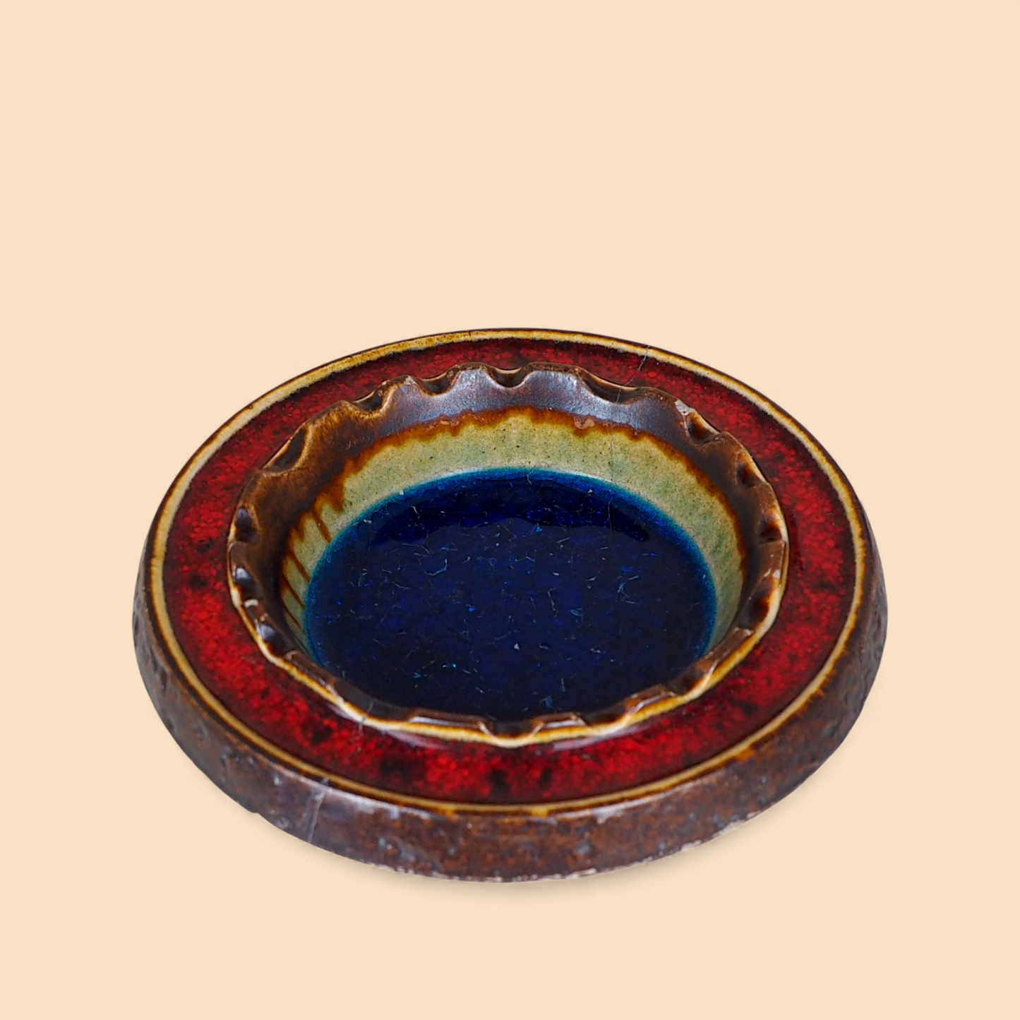 Popielniczka ceramiczna fat lava z Niemiec, koncentryczne kręgi niebiesko-czerwone, widok pod kątem
