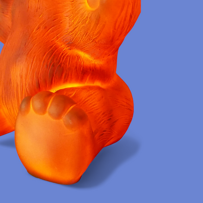 Detal plastikowej łapy lampki Heico miś z intensywnym czerwonym świeceniem